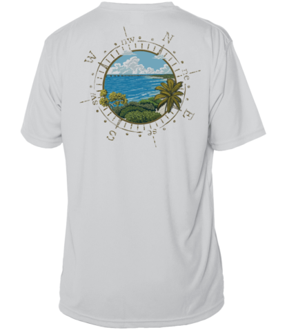 A white rash guard with an image of the ocean and palm trees.