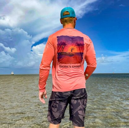 A man is standing in the ocean wearing a Grateful Angler Skeleton Anglers UV Shirt.