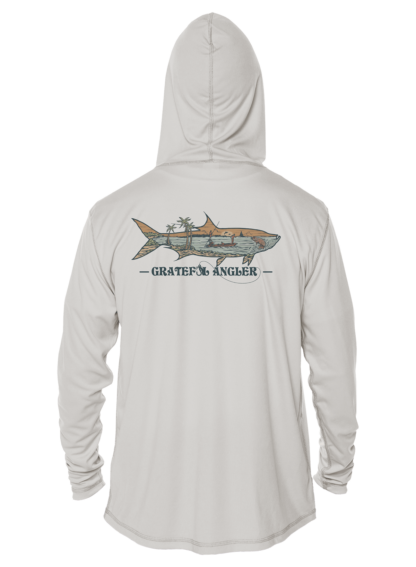 A man wearing a Grateful Angler Keys Tarpon UV Hoodie with an image of a shark on it.