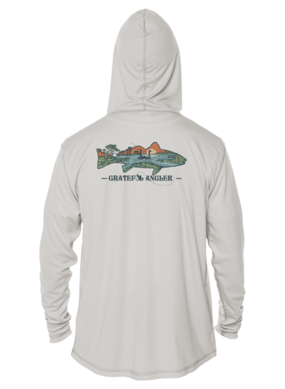 A man wearing a Grateful Angler Lowcountry Redfish UV Hoodie with an image of a plane on it.