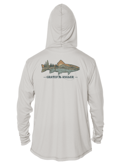 A man wearing a Grateful Angler Mountain Trout UV Hoodie with an image of a fish on it.