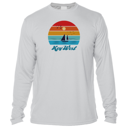 A long - sleeve t - shirt with a sailboat and sunset.