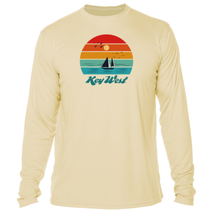 A long - sleeved t - shirt with a sunset and sailboats.