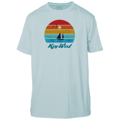 A light blue t - shirt with a sailboat and sunset.