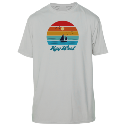 A white t - shirt with a sailboat and sunset in the background.