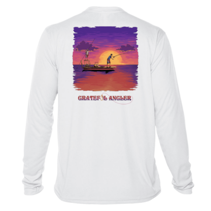A white long-sleeve Grateful Angler Skeleton Anglers UV Shirt featuring an image of a boat at sunset.