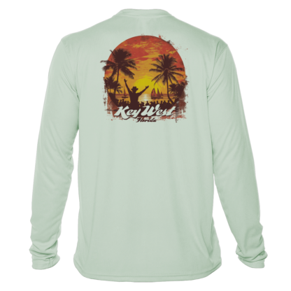 A long sleeve sun protective t-shirt with an image of a sunset and palm trees.