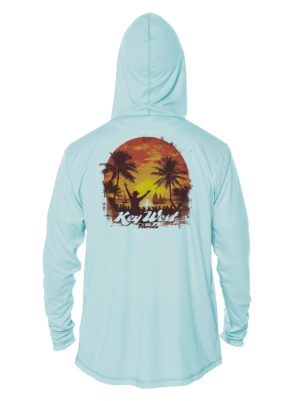A light blue swim shirt with a sunset and palm trees.