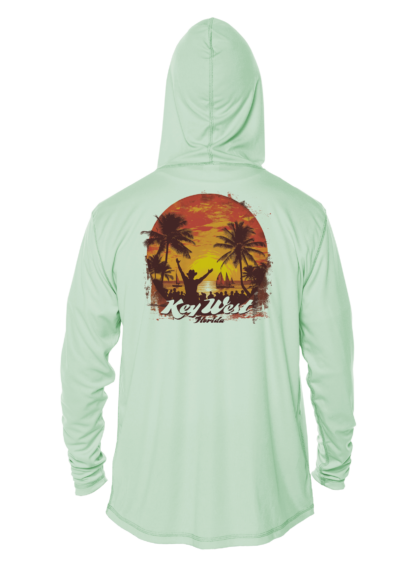 A green rash guard with a sunset and palm trees.